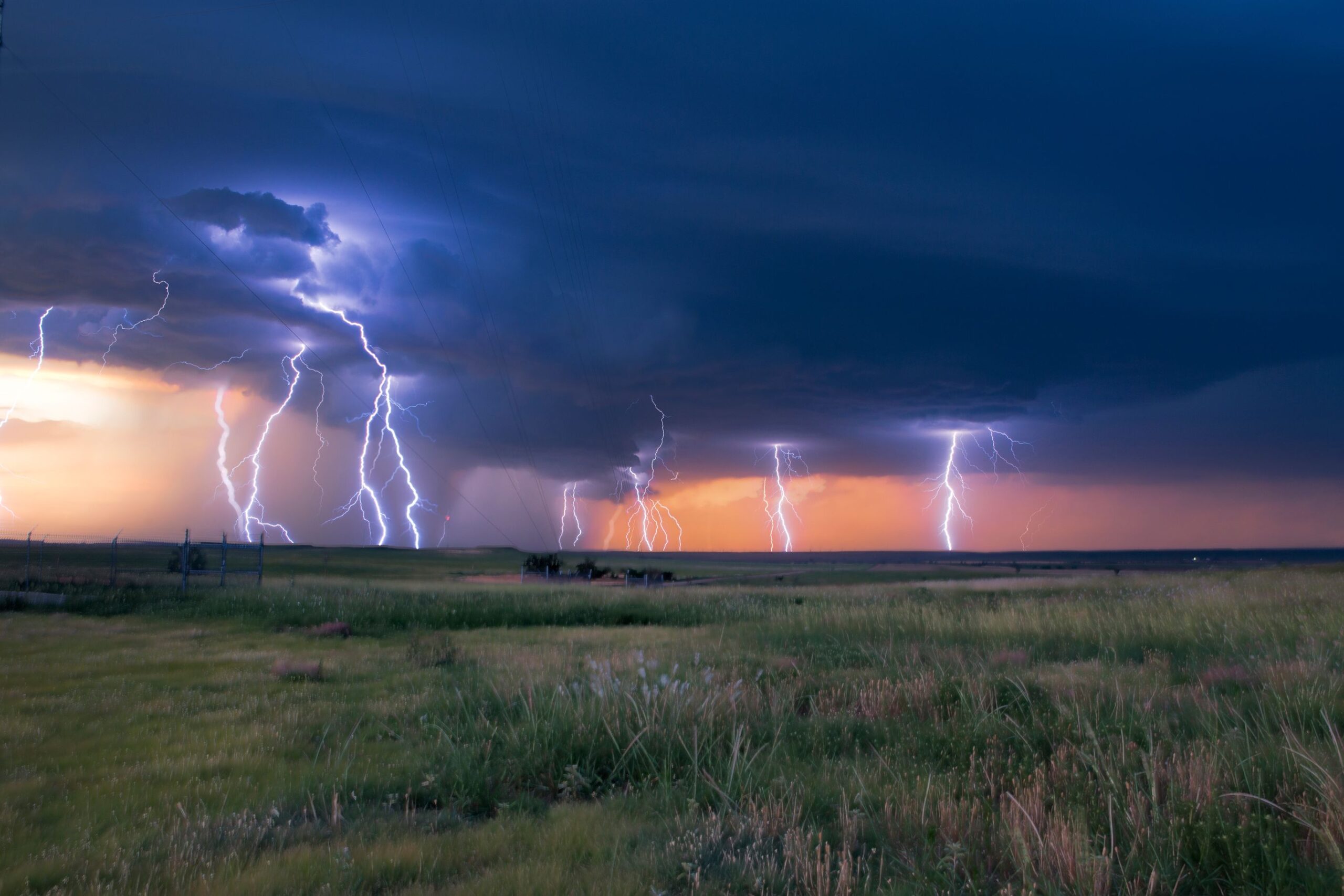 A photography timelapse of lightning across the prairies of Clark County Kansas at sunset.