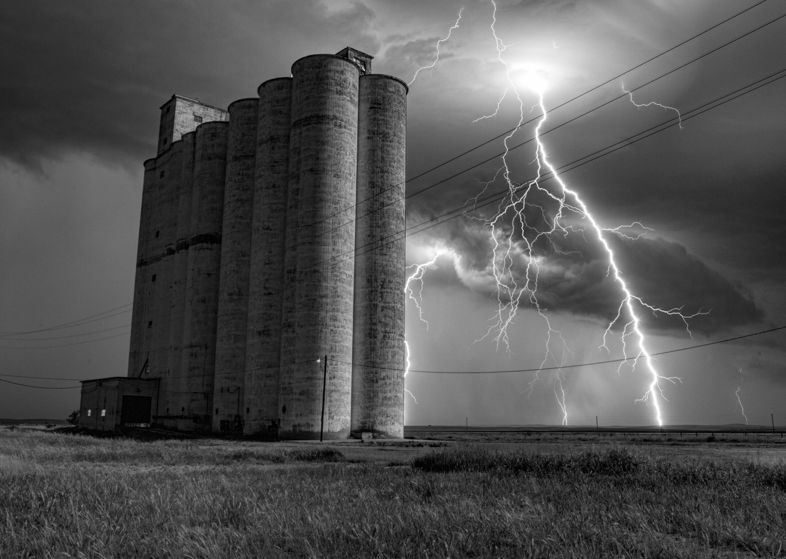 Multiple bolts of staccato lightning strike near the Sitka Elevator in Sitka Kansas