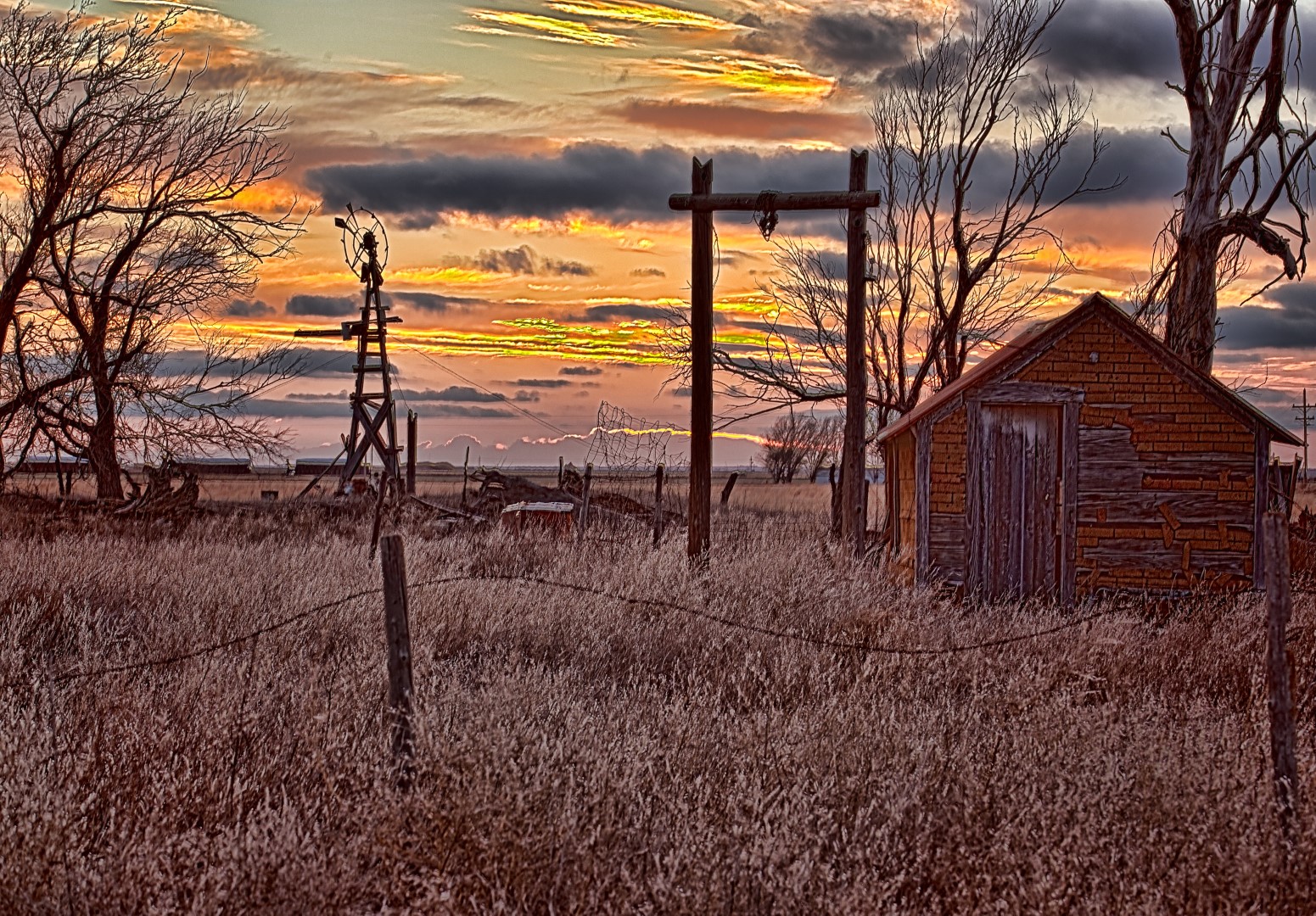 An HDR of a setting winter sun at an abandoned farm in western Finney County Kansas