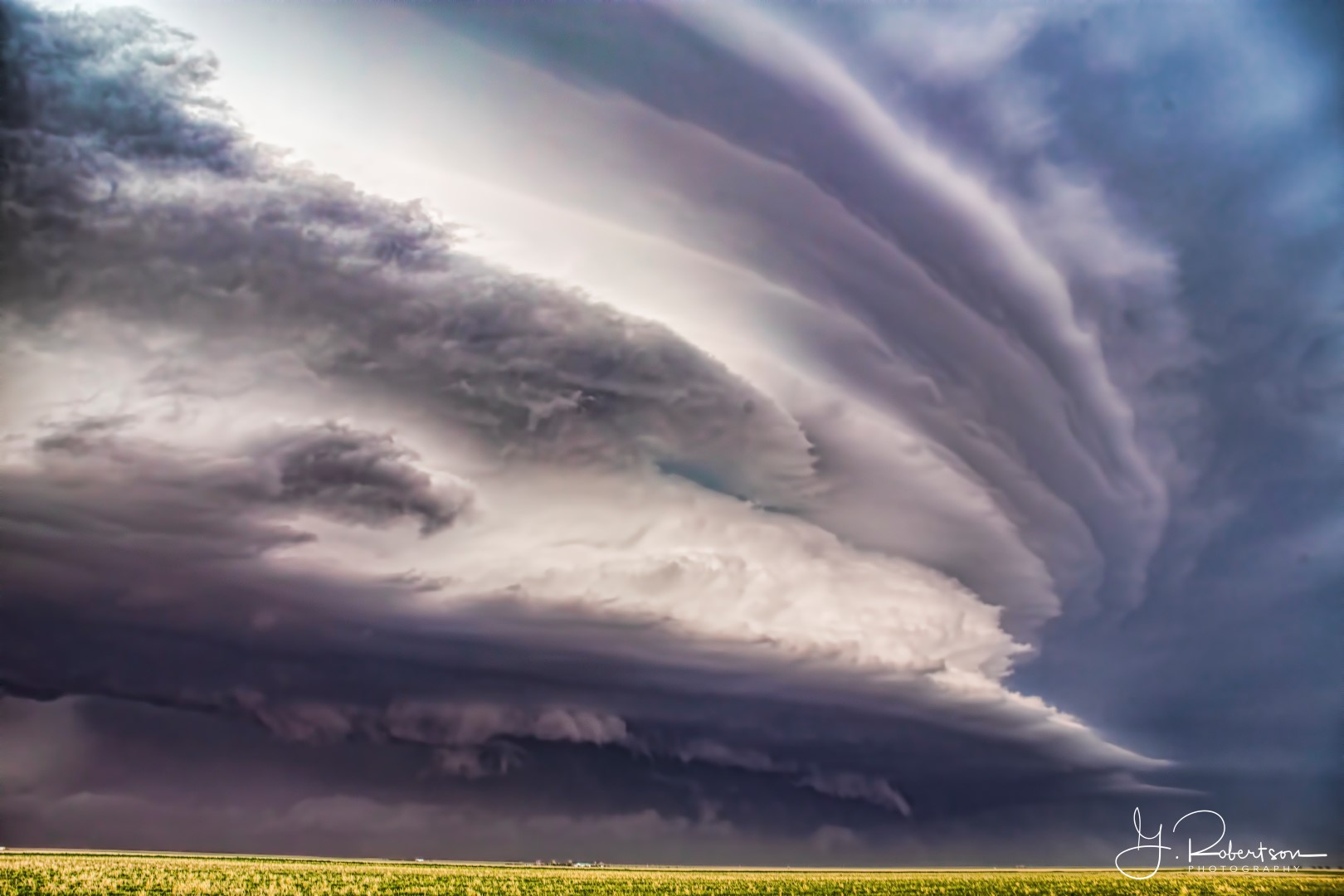 A severe thunderstorm moves across a canola field in Kiowa County Colorado