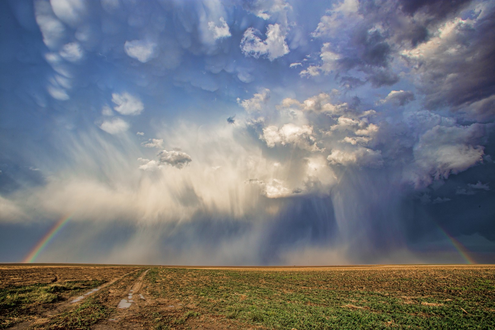 A rainbow forms amidst a hail shaft on a thunderstorm in Hamilton County Kansas
